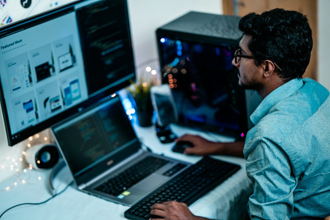 IT engineer monitoring systems across several screens